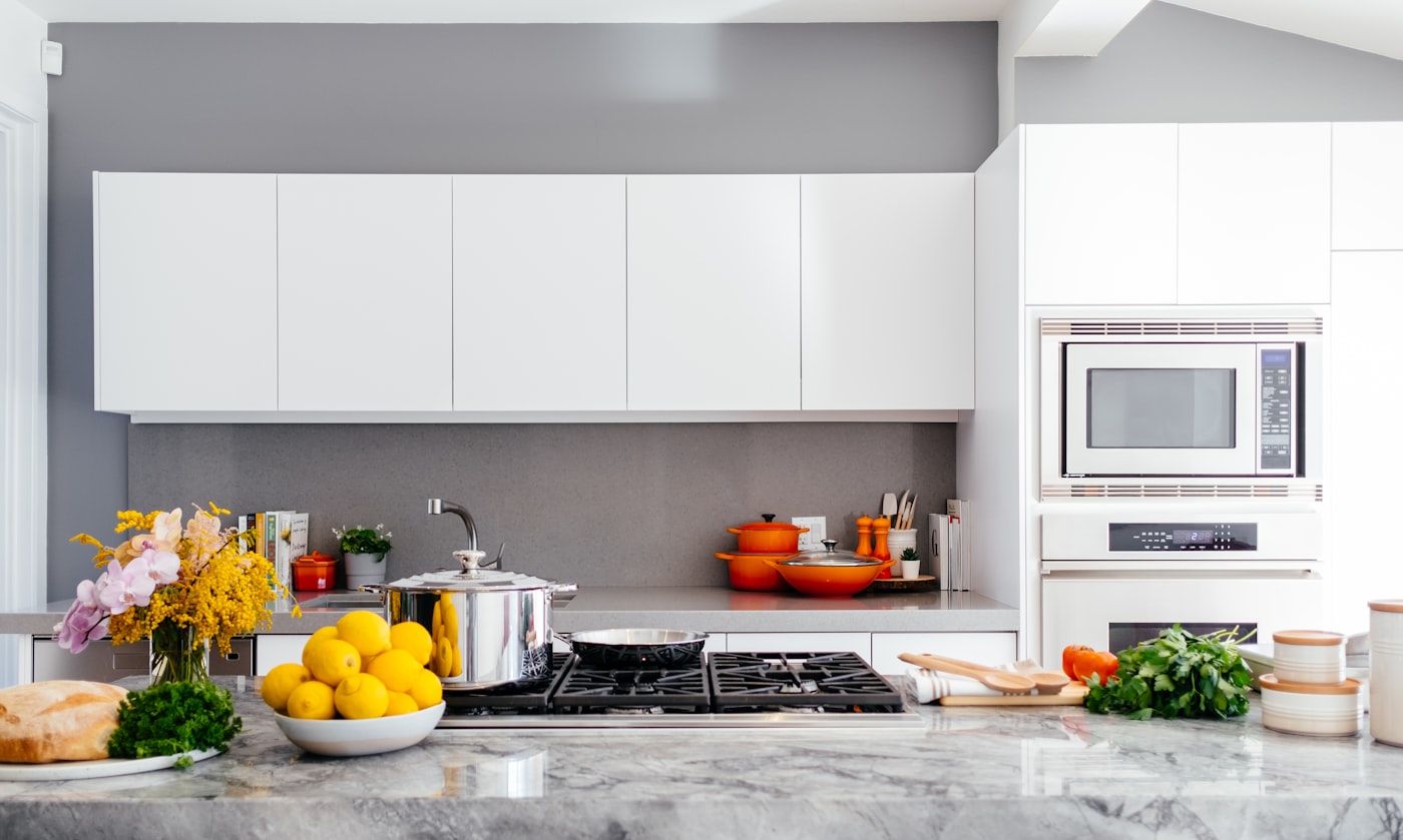 A bright, modern kitchen with natural light and fresh flowers on the counter